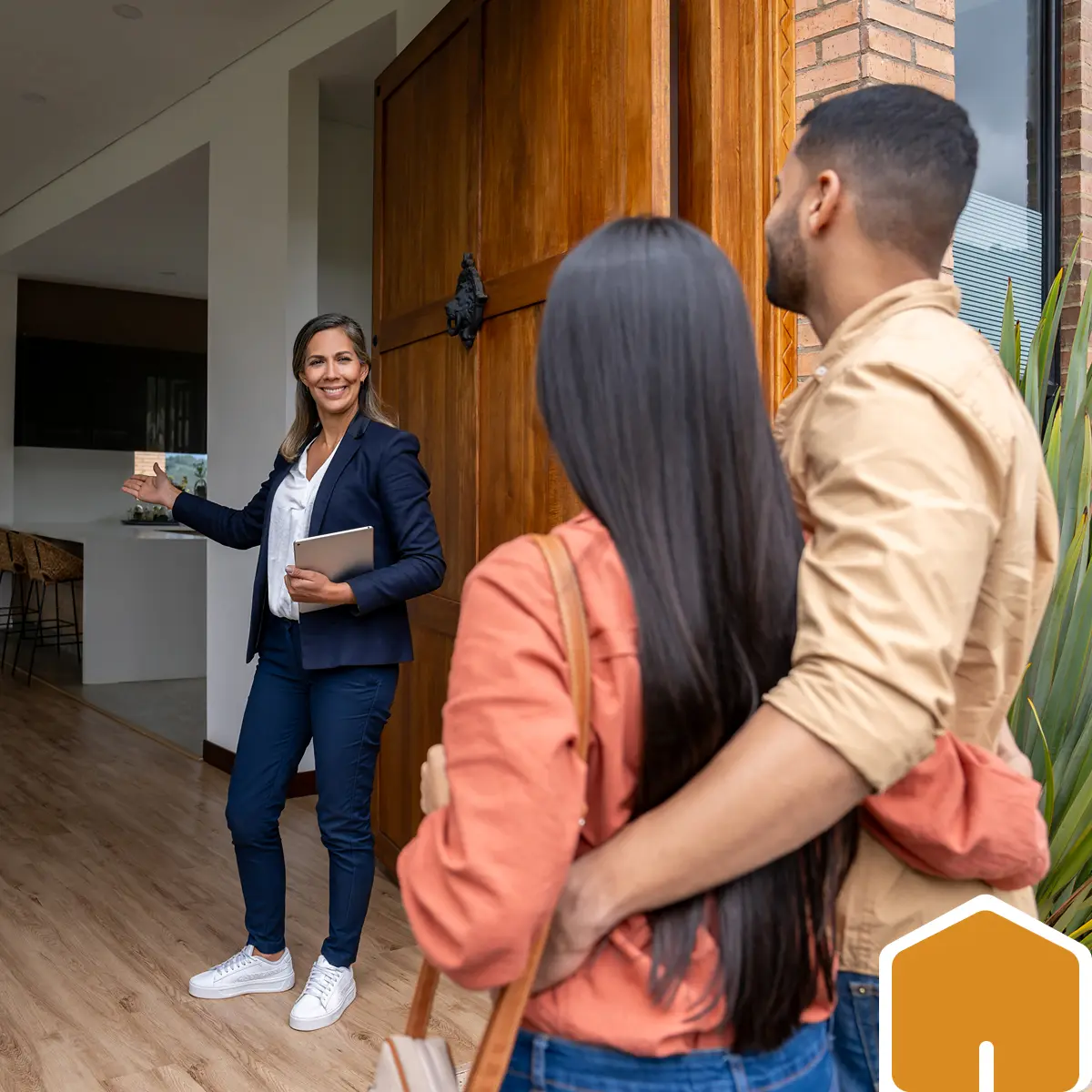 Realtor welcoming couple to open house